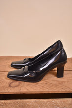 Load image into Gallery viewer, Gucci black heels are shown from the side. The shoes have a square toe.