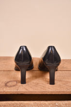 Load image into Gallery viewer, Gucci heels are made from black leather. The shoes are shown from the back.
