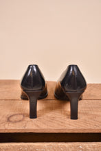 Load image into Gallery viewer, Gucci heels are made from black leather. The shoes are shown from the back.