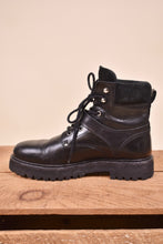 Load image into Gallery viewer, All Saints vintage boots are shown from the side. The boots are made from black leather.
