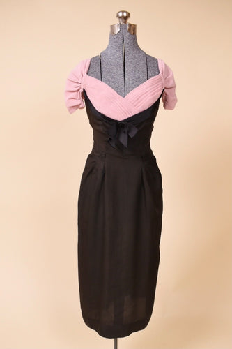 Black and pink dress is shown from the front. The dress is fitted.