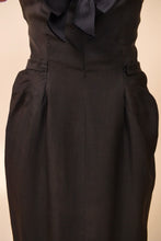 Load image into Gallery viewer, Lower front of black and pink dress is shown up close. The lower front features darts for shape.
