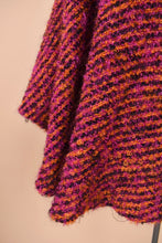 Load image into Gallery viewer, Vintage pink and orange knit cape is shown in close up. This wool cape has a fuzzy boucle knit.