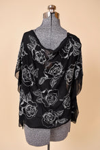 Load image into Gallery viewer, Vintage white house black market beaded sheer black blouse is shown from the back. This drapey sheer blouse has cold shoulder details. 
