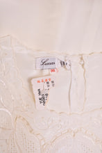 Load image into Gallery viewer, Vintage 80&#39;s ivory lacy blouse is shown in close up. 
