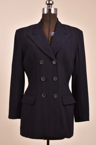 Vintage black designer pinstripe tailored blazer is shown from the front. This blazer has six buttons on the front. 