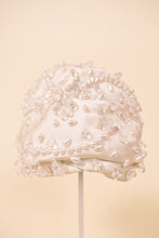 Load image into Gallery viewer, Vintage 50s white silk Christian Dior turban cap is shown from the front. This bejeweled designer turban has beaded designs. 
