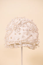 Load image into Gallery viewer, Vintage 50s white silk Christian Dior turban cap is shown from the front. This bejeweled designer turban has beaded designs.