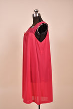 Load image into Gallery viewer, Vintage midi length hot pink nightgown dress is shown from the side. 
