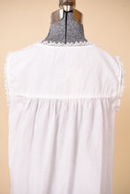 Load image into Gallery viewer, Vintage white lace nightgown mini dress is shown in close up. This dress has a yoke at the back shoulders. 
