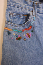 Load image into Gallery viewer, Vintage nineties whimsical DIY beaded jeans by Blue Star are shown in close up. 
