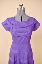 Load image into Gallery viewer, Vintage bright purple tea dress is shown from the front. This dress has a wide boatneck.