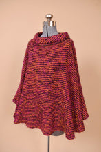 Load image into Gallery viewer, Vintage woven pink and orange turtleneck poncho is shown from the side. This poncho is made from Irish wool by Donegal Design.
