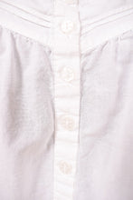 Load image into Gallery viewer, Vintage nineties white cotton pajama mini dress is shown in close up. This dress has white plastic flower print buttons down the front. 
