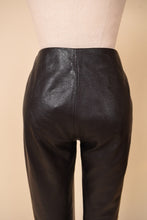 Load image into Gallery viewer, Vintage low rise pocketless moto dark brown leather pants are shown in close up. 
