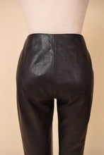 Load image into Gallery viewer, Vintage low rise pocketless moto dark brown leather pants are shown in close up.