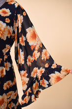 Load image into Gallery viewer, Vintage designer Betsey Johnson navy blue and orange flower print mini dress is shown in close up. This dress has wide bell sleeves with a ruffle hem.