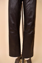 Load image into Gallery viewer, Vintage dark brown leather moto pants are shown in close up. These low rise leather pants have a straight leg fit. 
