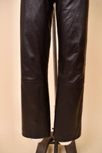 Load image into Gallery viewer, Vintage dark brown leather moto pants are shown in close up. These low rise leather pants have a straight leg fit.