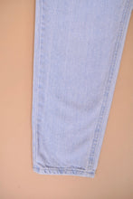 Load image into Gallery viewer, 1990&#39;s vintage powder blue tapered mom jeans by Riders are shown in close up. These jeans have a tapered fit through the leg. 
