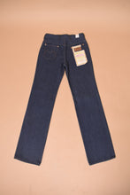 Load image into Gallery viewer, The jeans lie flat on the ground. The back of the jeans is visible.
