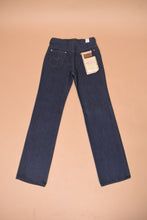 Load image into Gallery viewer, The jeans lie flat on the ground. The back of the jeans is visible.