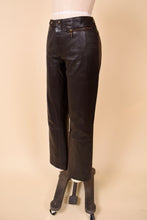 Load image into Gallery viewer, Vintage brown leather Y2K pants are shown from the side. These pants have moto inspired hardware at the waist.
