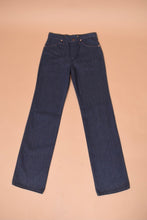 Load image into Gallery viewer, The jeans lie flat on the ground. The front faces up.