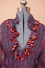 Load image into Gallery viewer, The low v neck and high collar are visible up close.