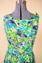 Load image into Gallery viewer, Vintage sixties blue and green girly floral print dress is shown in close up. This dress has a high boat neckline. 
