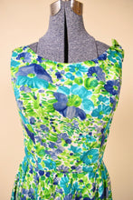Load image into Gallery viewer, Vintage sixties blue and green girly floral print dress is shown in close up. This dress has a high boat neckline.