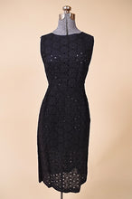 Load image into Gallery viewer, Vintage 1950&#39;s black eyelet midi length dress by Puritan is shown from the front. This dress has a high boat neckline. 
