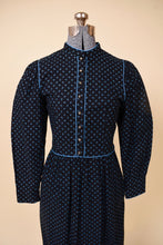 Load image into Gallery viewer, Vintage black and blue flower print midi prairie dress by Lanz is shown in close up. This dress has a high neckline with blue piping.