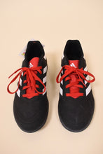 Load image into Gallery viewer, Vintage Adidas low top soccer cleats are shown from above. These cleats are black with three white stripes. 
