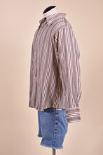 Load image into Gallery viewer, Vintage 70&#39;s brown and white button down top is shown from the side. 
