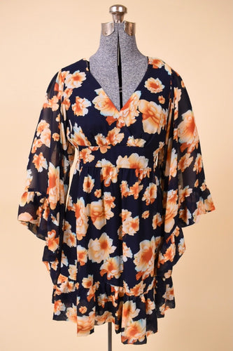Vintage Y2K navy blue and orange floral flowy mini dress is shown from the front. This dress has flowy bell sleeves.