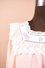Load image into Gallery viewer, Vintage peach sleepwear maxi dress shown in close up. This dress has a white lace bib collar with pink floral embroidery.
