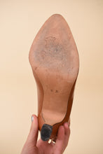 Load image into Gallery viewer, Vintage Escada caramel brown leather pumps are shown from the bottom. 
