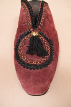 Load image into Gallery viewer, Red suede slip on mules are shown from the front. These mules have gold and black embroidered details.
