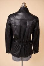 Load image into Gallery viewer, Vintage black leather motorcycle jacket is shown from the back. 
