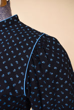 Load image into Gallery viewer, Vintage black 70s cotton prairie dress is shown in close up. This seventies Lanz dress has puff sleeves with ruched shoulder details.