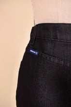 Load image into Gallery viewer, Vintage high rise dark denim flare jeans by Jordache are shown in close up. These jeans have a little blue tag that reads Jordache.
