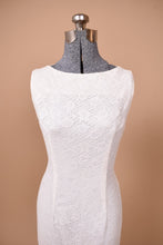 Load image into Gallery viewer, Vintage 60s white lace sleeveless mermaid dress is shown from the front. This dress has a high neckline.
