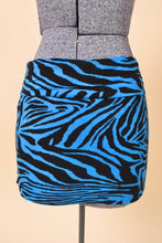 Load image into Gallery viewer, Vintage early 2000&#39;s colorful blue zebra print mini skirt is shown from the back. This skirt has a foldover waistband.
