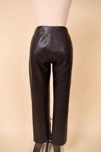 Load image into Gallery viewer, Vintage low rise dark brown leather trouser pants are shown from the back. These pants are by the brand Identify.