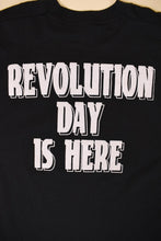 Load image into Gallery viewer, Vintage 1980s black and white graphic tee is shown in close up. This tee shirt reads Revolution Day is Here on the back. 
