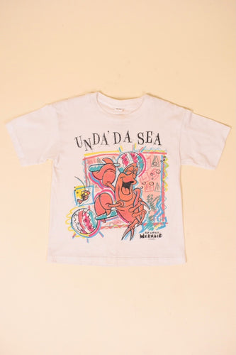 Vintage white cropped single stitch 80's Unda Da See little mermaid shirt is shown from the front. 
