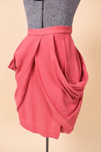 Load image into Gallery viewer, Vintage rose pink Miu Miu skirt is shown from the side. This skirt has dramatic gathered draped details. 
