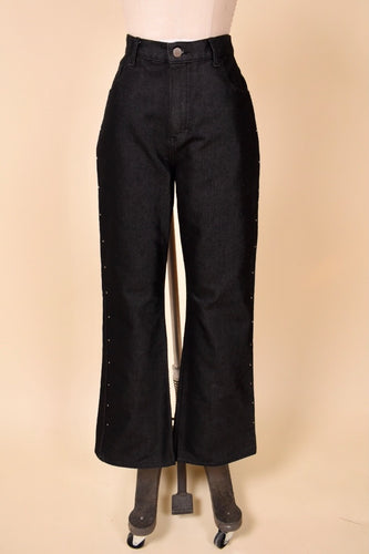 Vintage black dark wash flare jeans by Jordache are shown from the front. These black bell bottom flares are by Jordache. 