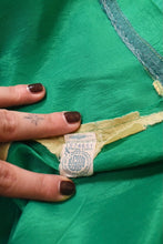 Load image into Gallery viewer, Vintage union made green acetate 60&#39;s party dress is shown in close up. This dress has an ILGWU union label. 
